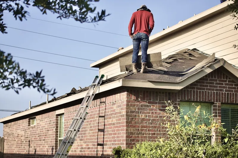 Professional roofer working on a residential roof in Old Colorado City